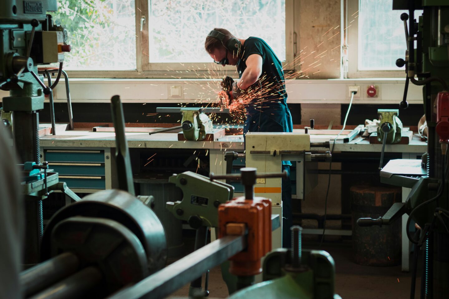 Designer in his workshop, creating an online portfolio to showcase his handcrafted furniture.