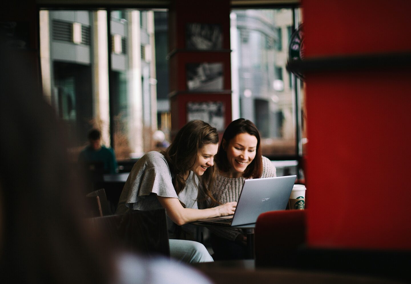 Two entrepreneurs working on their about section seated on a sofa 