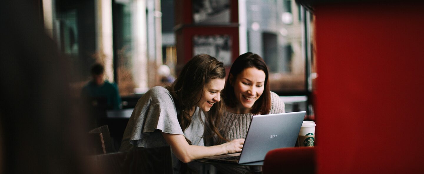 Two entrepreneurs working on their about section seated on a sofa