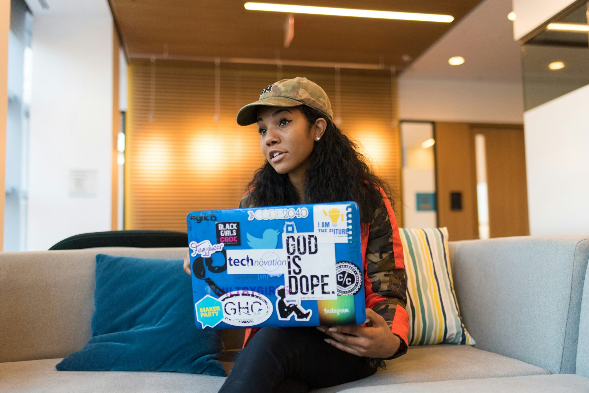 Female entrepreneur with a laptop working on a cozy sofa